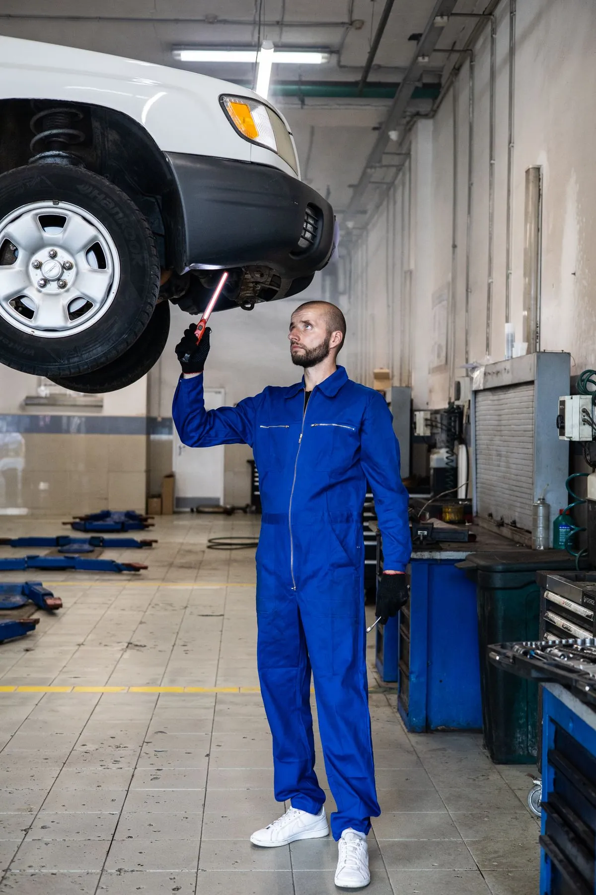 A car wheel showing uneven tyre wear from poor alignment