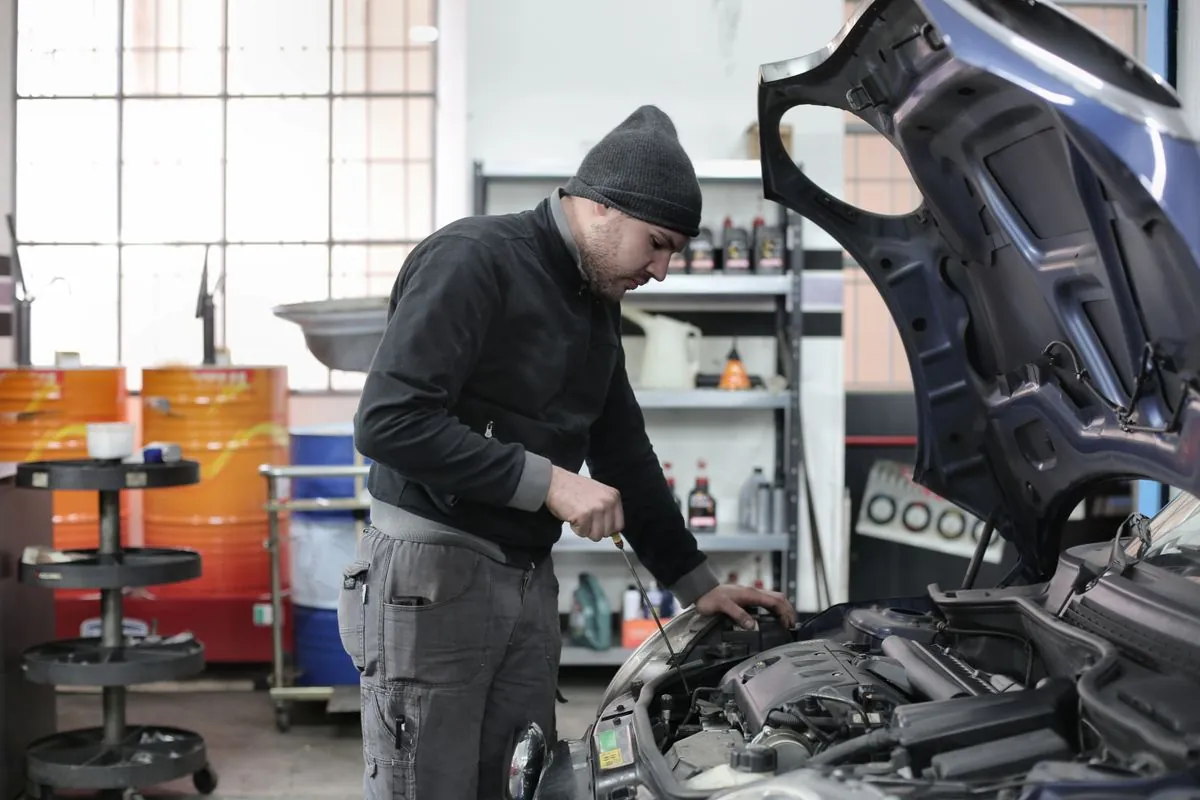 A mechanic assessing whether a tyre needs repair or replacement