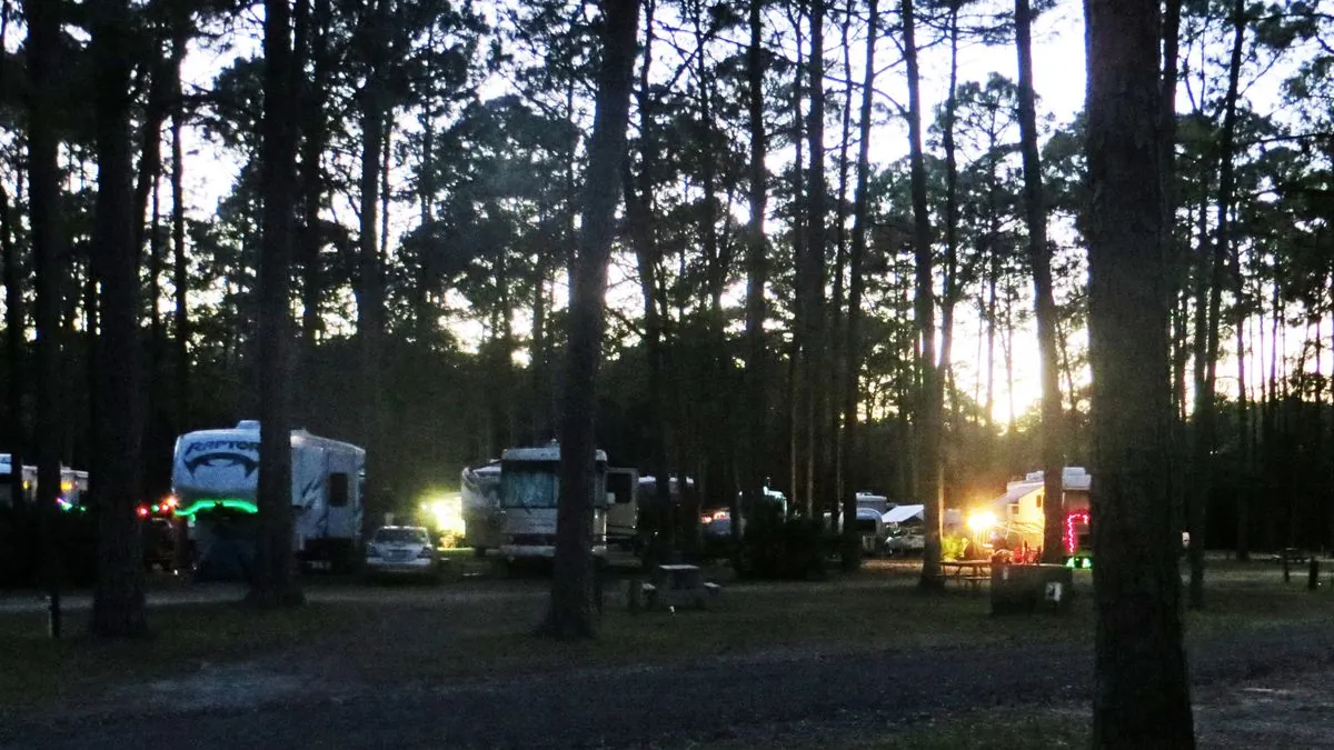 A motorhome parked at a campsite with the focus on its tyres