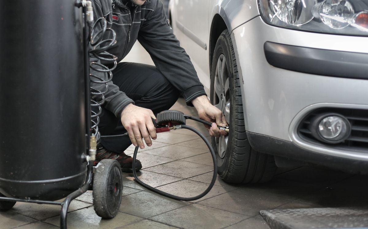 A tyre pressure monitoring sensor being serviced by a fitter