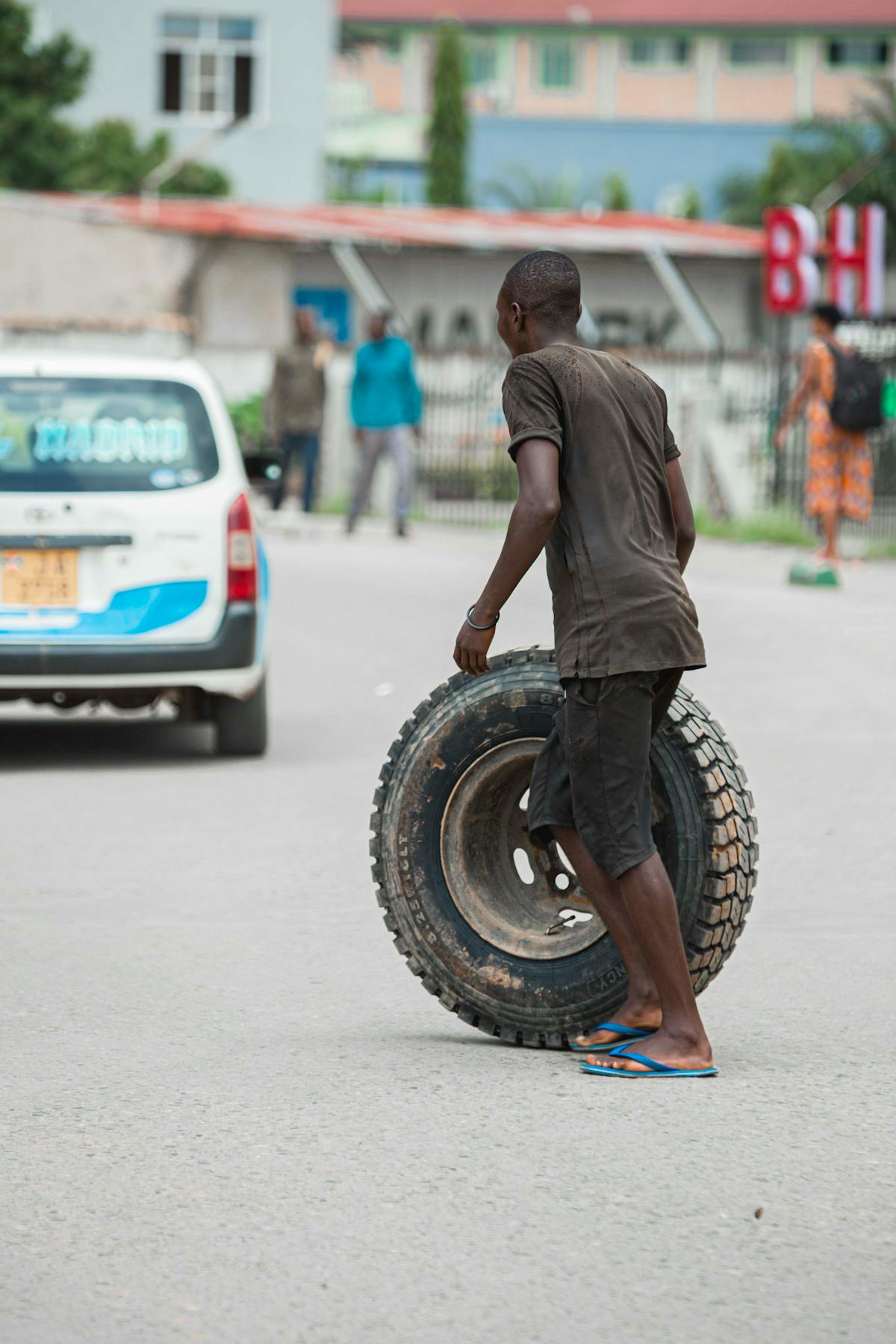 A roadside tyre sealant kit being used on a punctured car tyre