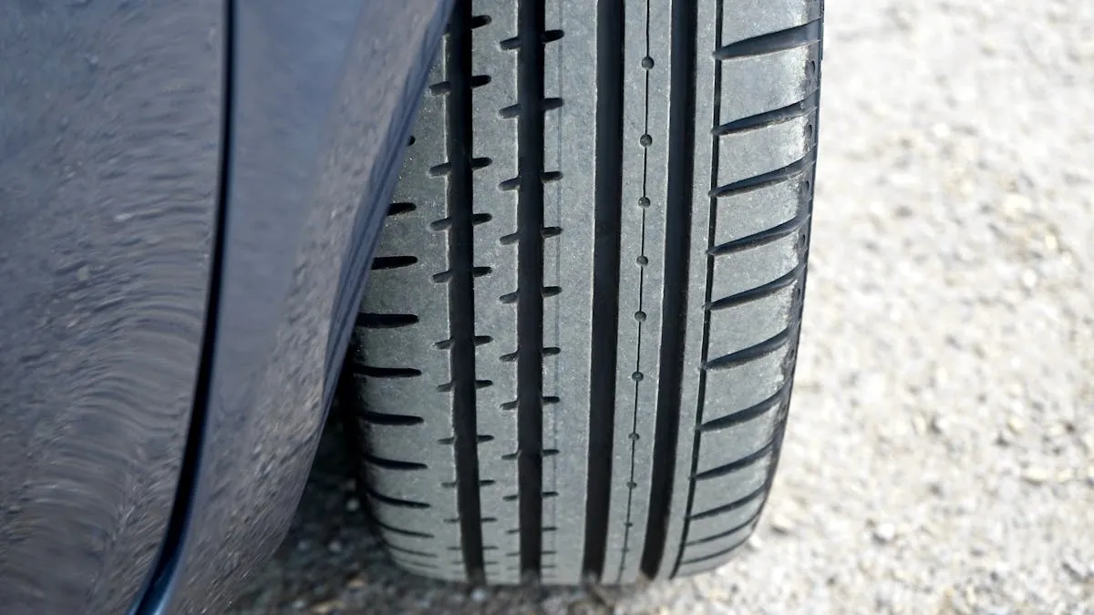 A 20 pence coin being used to check the tread depth of a car tyre