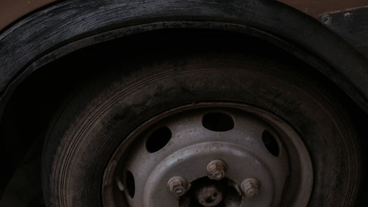 Close-up of a tyre valve being checked for leaks
