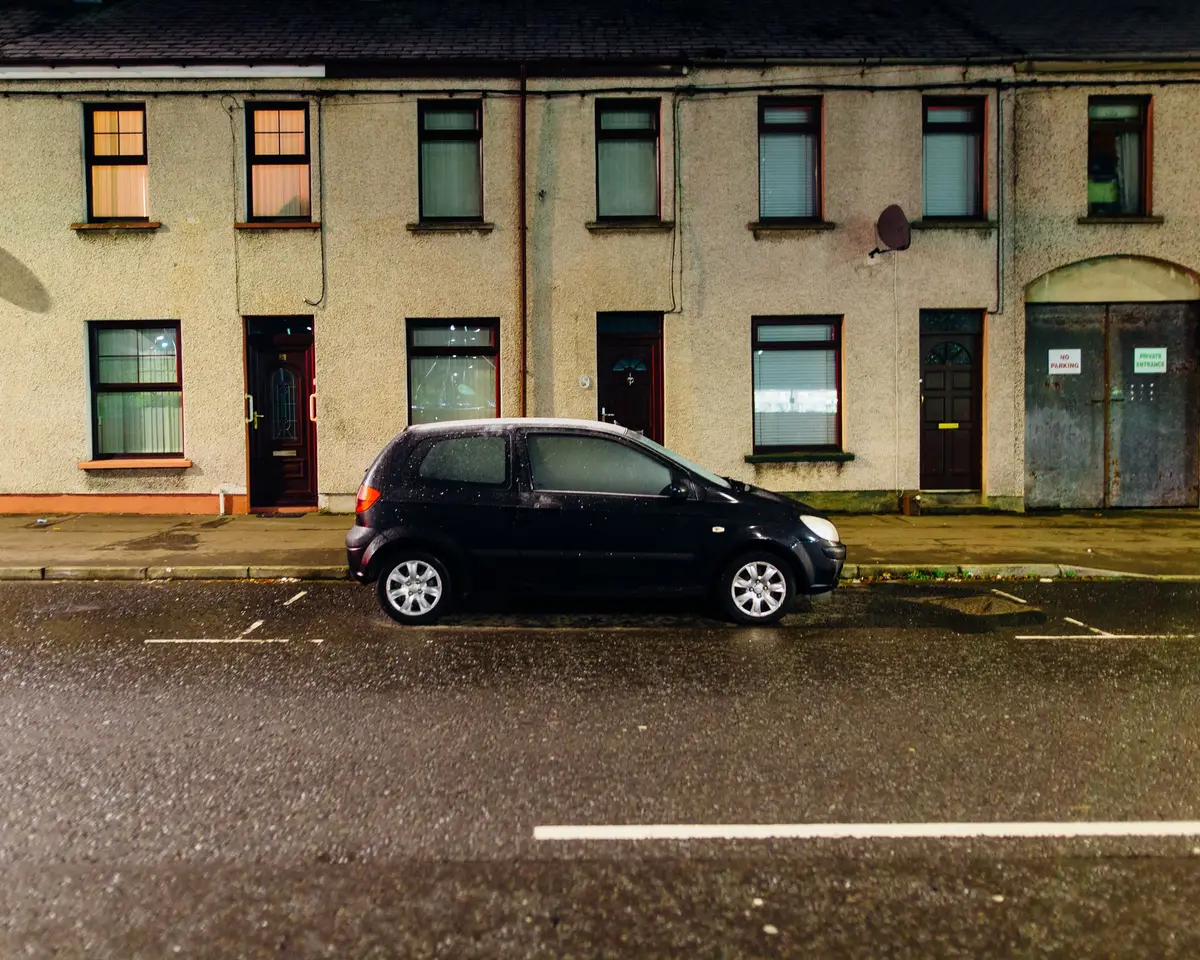 Hatchback parked on a wet evening street